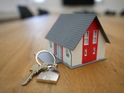 Estate agent handing keys to a new homeowner, representing trust and local presence in the property market