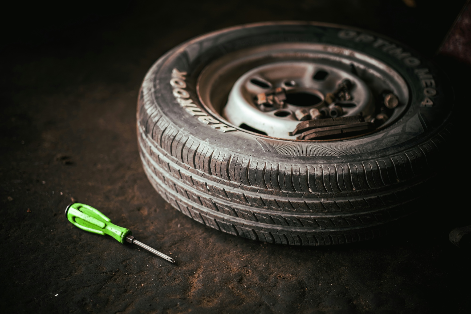 A tyre with a wrench next to it, representing independent car garages and automotive repair