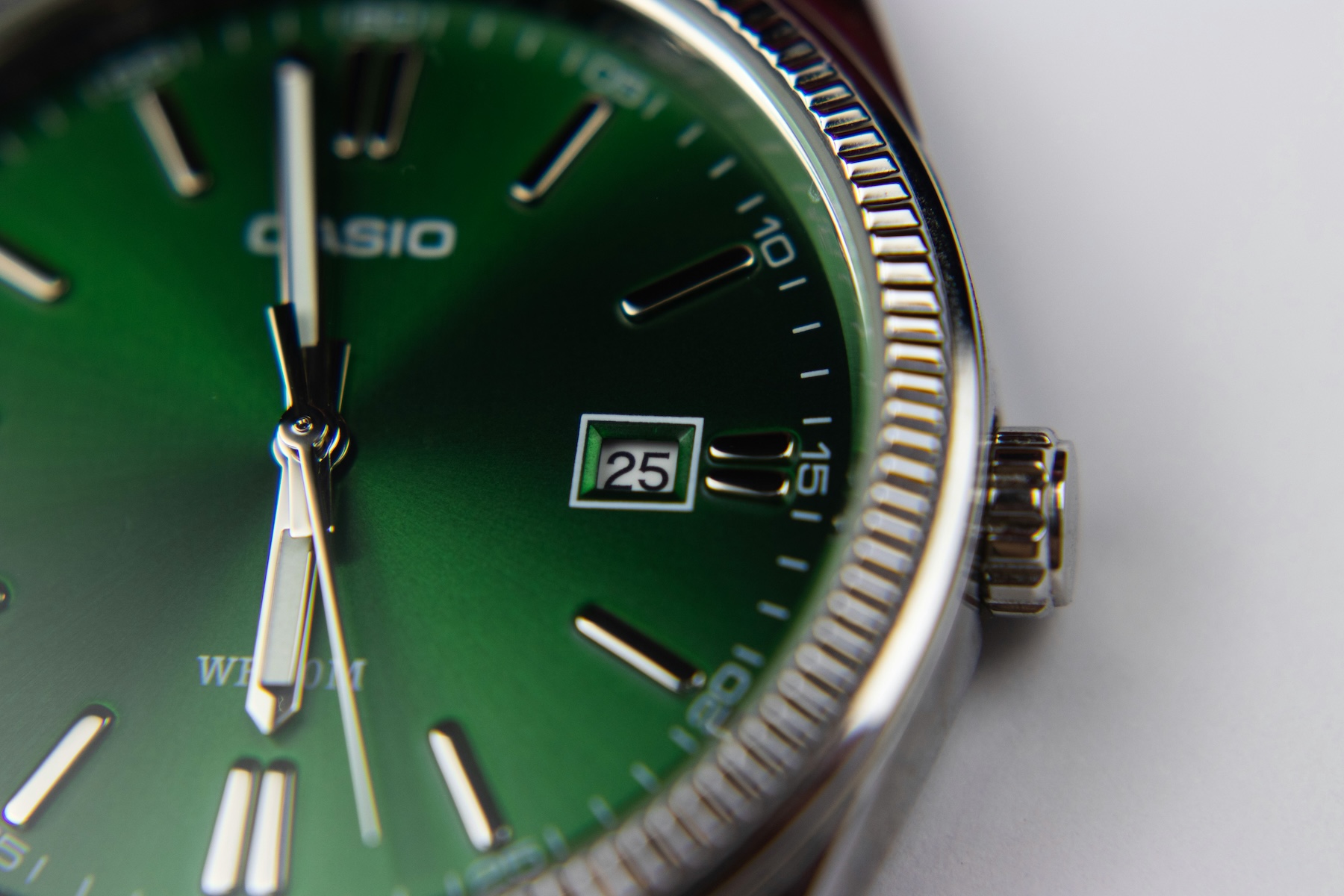 Close-up of a green-dialled Casio wristwatch, representing the reliability and uptime of virtual phone numbers for business use