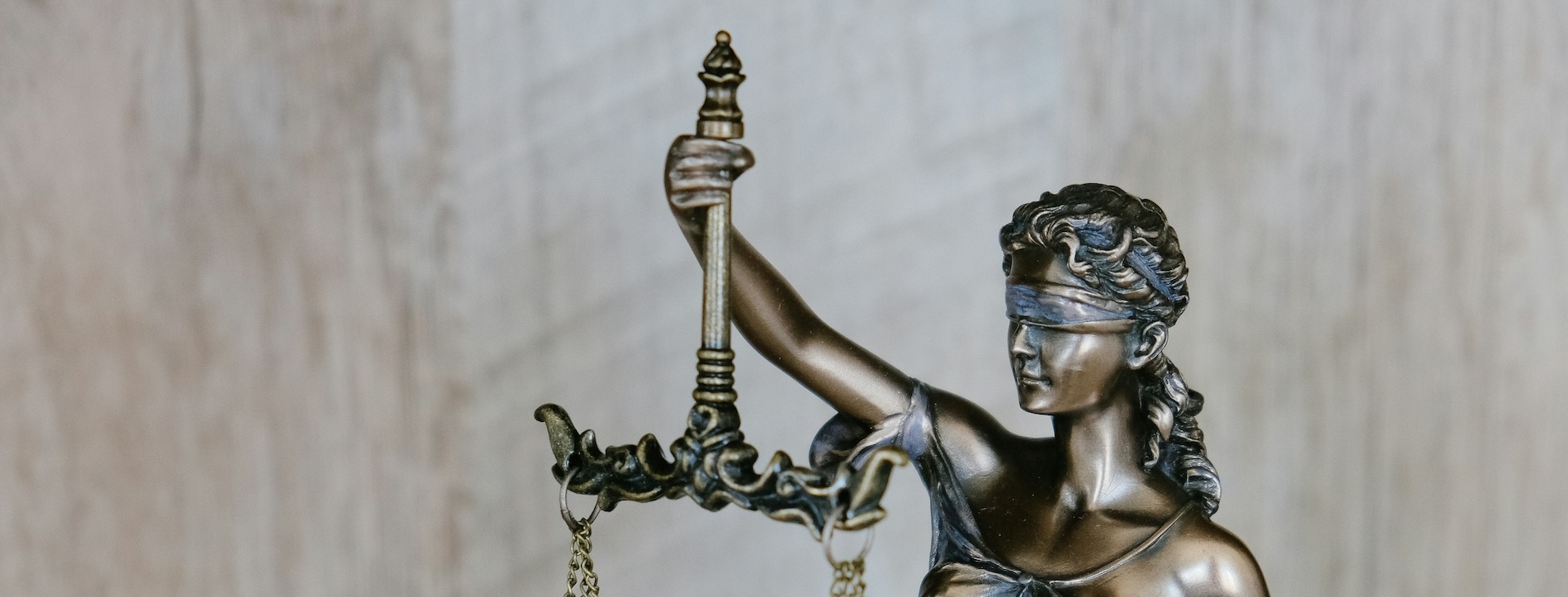 Lady Justice statue holding scales during daytime, representing the legal profession