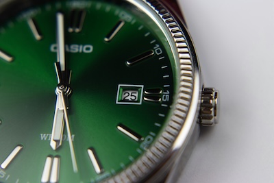 Close-up of a green-dialled Casio wristwatch, representing the reliability and uptime of virtual phone numbers for business use