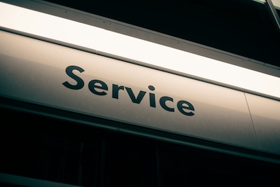 Illuminated Service sign on a building, representing local service businesses and customer trust