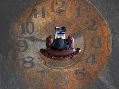 Person working on a laptop while sitting on a chair, overlaid on a large clock face, representing the PSTN switch-off countdown