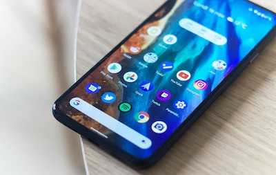 A smartphone on a wooden table, representing using a virtual phone number on a mobile phone